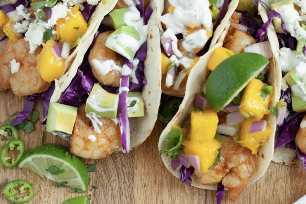 My Shrimp Tacos with mango salsa are out of this world! In these tacos, you’ll find Sriracha-infused shrimp, a smooth cilantro cream, and a mouthwatering homemade mango salsa. Everything is made from scratch and I’m showing you how you can make your own with my easy recipe!