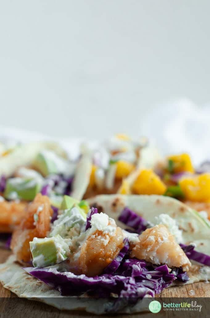 My Shrimp Tacos with mango salsa are out of this world! In these tacos, you’ll find Sriracha-infused shrimp, a smooth cilantro cream, and a mouthwatering homemade mango salsa. Everything is made from scratch and I’m showing you how you can make your own with my easy recipe!