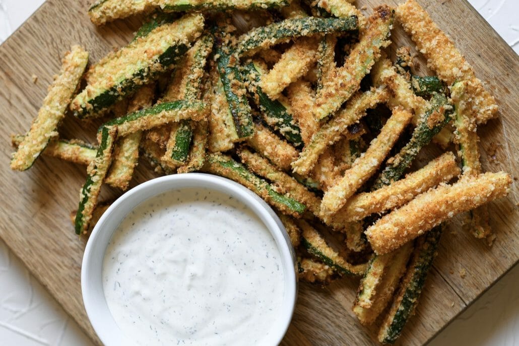 These oven-baked zucchini fries are SO easy to whip-up and are full of delicious flavor. Plus, paired with my homemade Avocado Ranch, your family will gobble them up in minutes!
