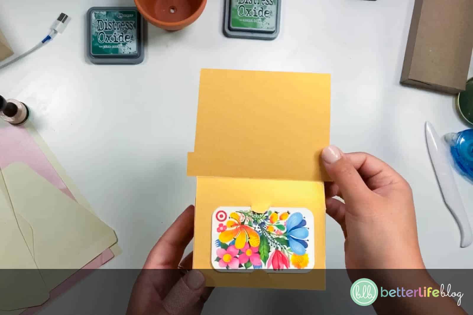 Inserting a gift card in our DIY cardstock gift card holder, made all thanks to our Cricut machine