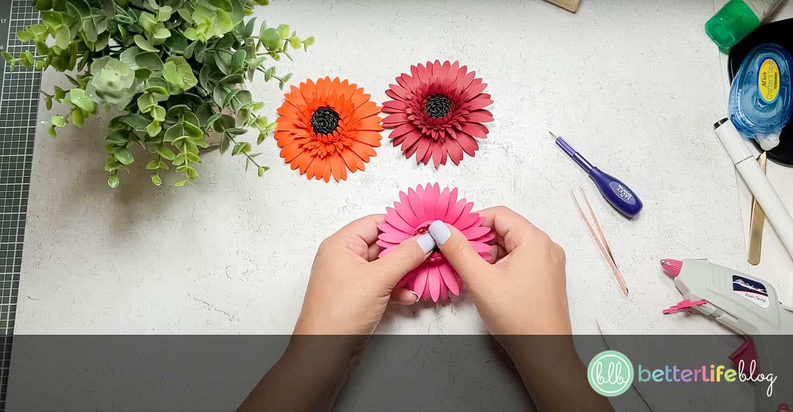 Using thumbs to open paper petals to give Paper Gerbera Daisies a realistic look