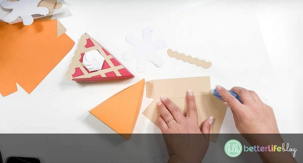 Adding crafter's tape to brown cardstock in the shape of a pie slice