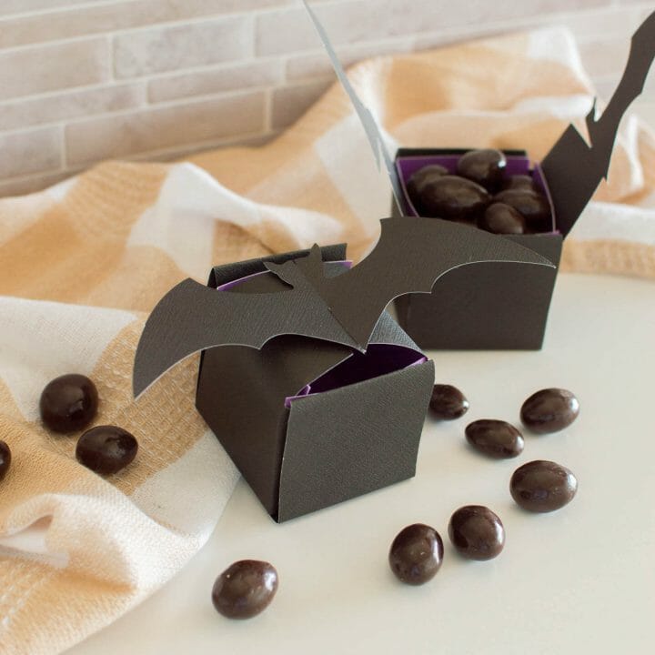 Halloween Bat Treat Box filled with chocolate-covered almonds and surrounded by a plaid napkin