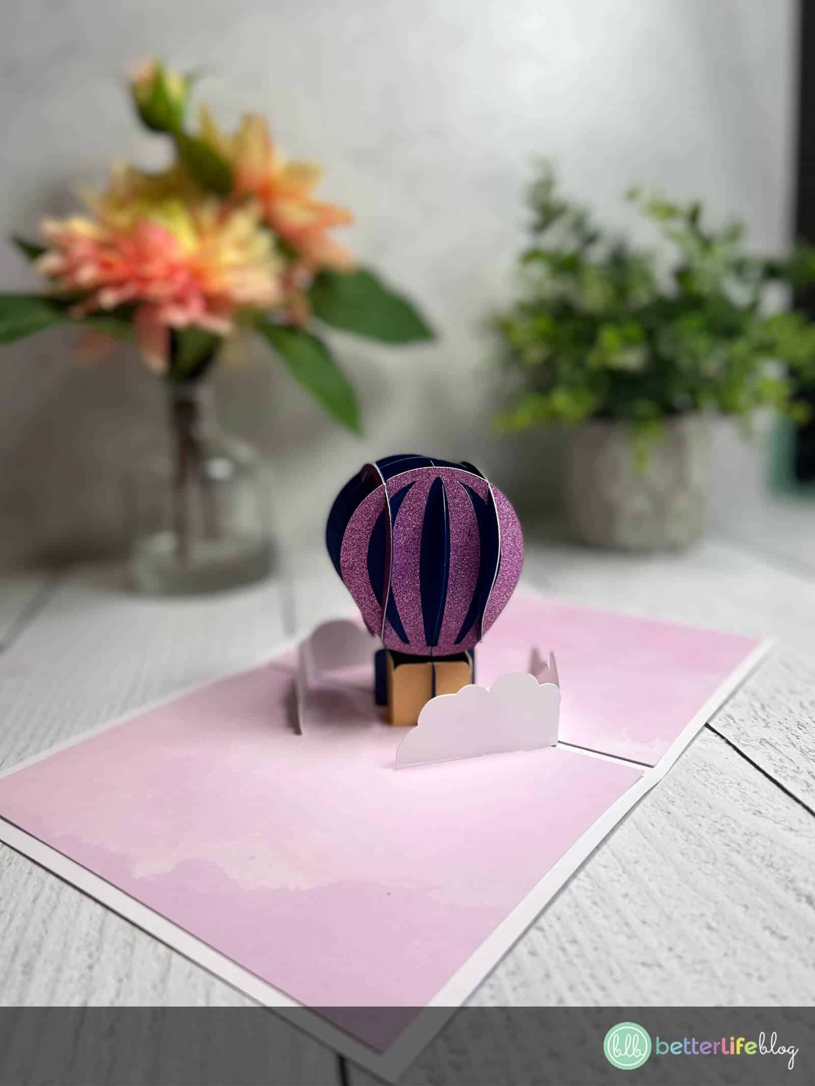 Want to learn how to make a pop-up card with your cutting machine? This Cricut Hot Air Balloon Pop-Up Card is an easy one to whip-up! Check out my full tutorial so you can make and customize one of your very own!