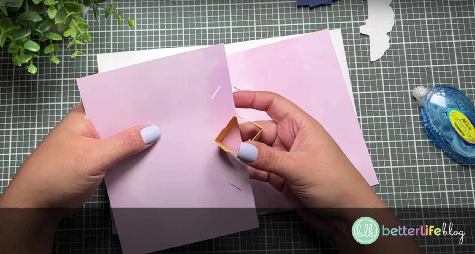 Inserting Hot Air Balloon Pop-Up Card base into the center of the card