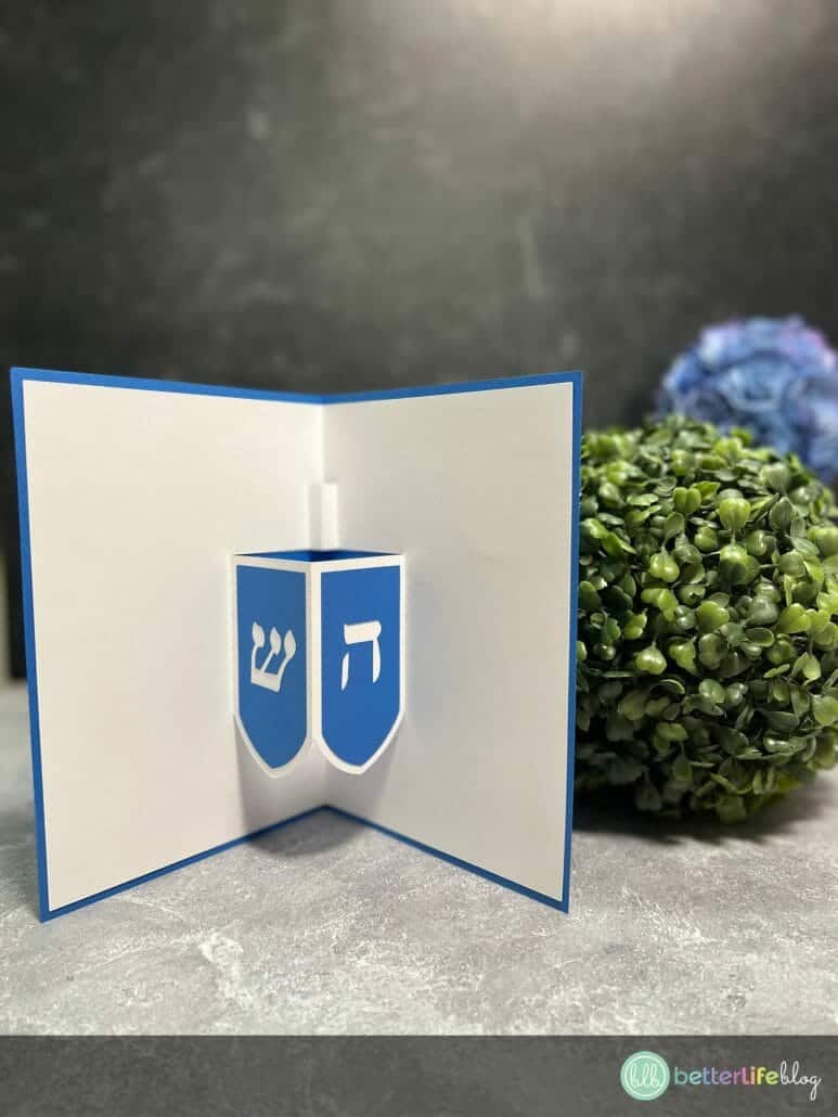 Hanukkah Sameach! We will soon be celebrating the Festival of Lights – so get your menorahs ready, and gather your loved ones! To commemorate this beautiful holiday, we have the cutest Hanukkah card template for you to use: and it’s a dreidel pop-up card, no less!