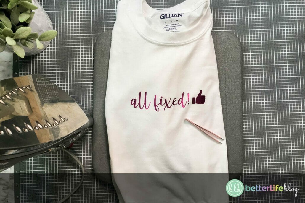 Pink HTV that says "All Fixed" on a white tshirt