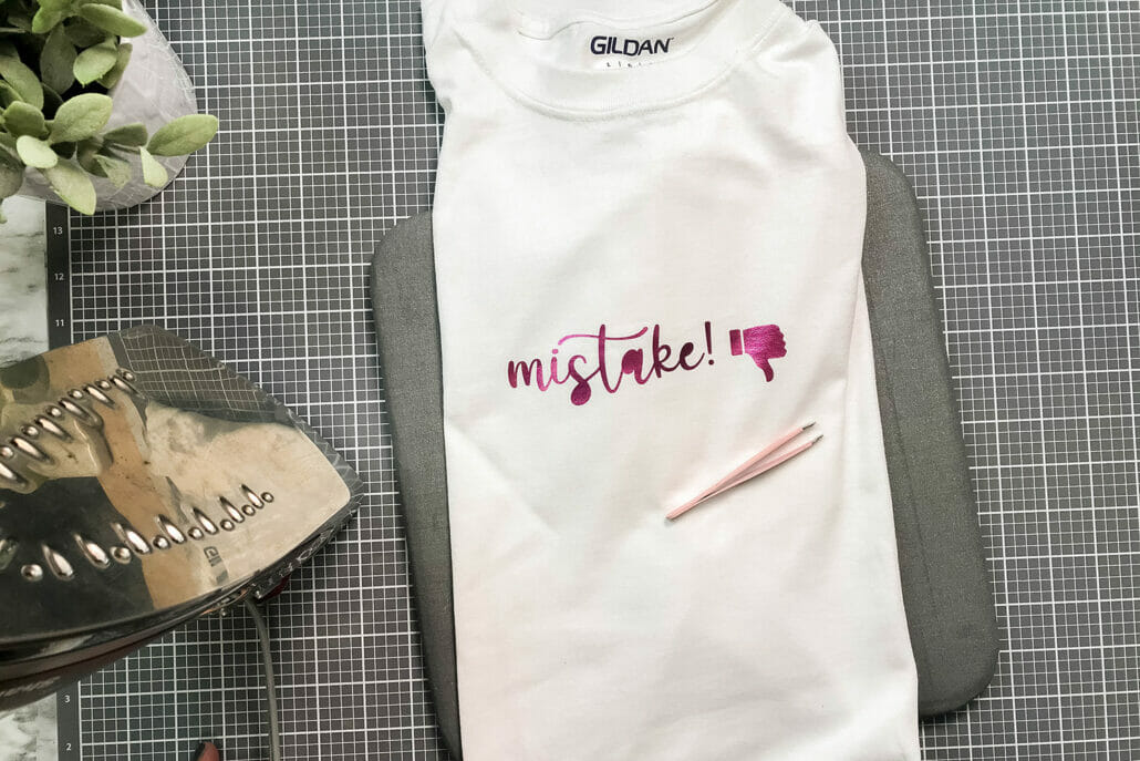 Pink HTV that says "Mistake" on a white tshirt