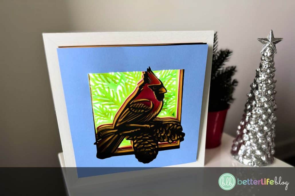 Looking for unique holiday Cricut projects? This Cardinal Shadow Box is the perfect DIY craft for Christmas! Layered cardstock, a little glue, and an SVG file bring this 3D festive design to life. Add it to your holiday décor or gift it to a loved one!