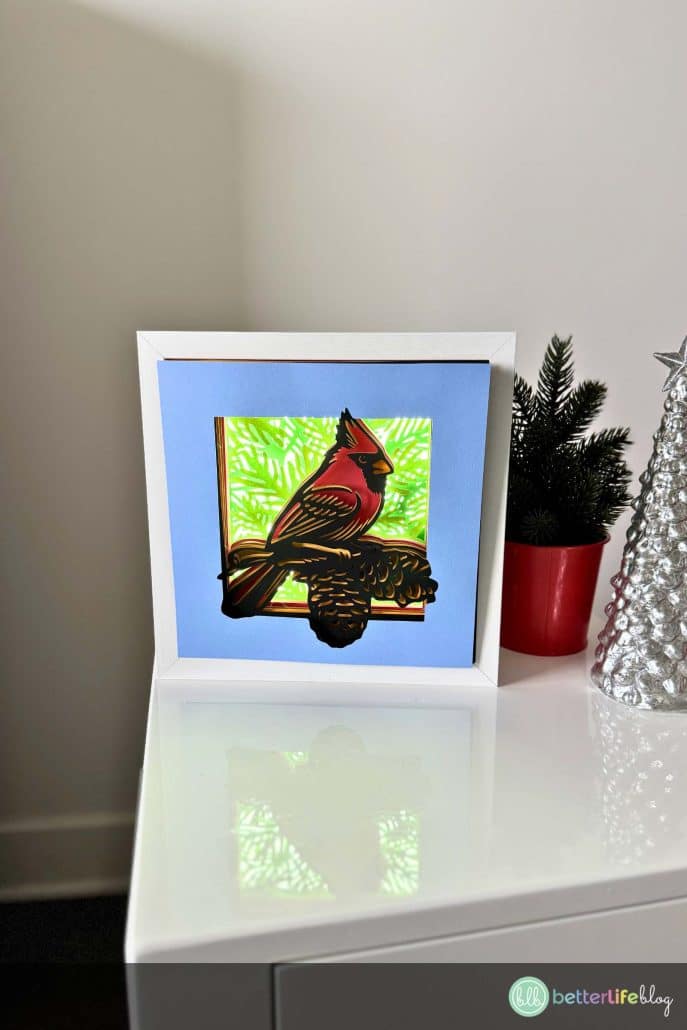 Create a stunning Cardinal Shadow Box for the holidays with your Cricut! This layered paper craft features a vibrant red cardinal perched in a winter wonderland. Perfect as Christmas décor or a handmade gift idea. Get the full tutorial and SVG file today!