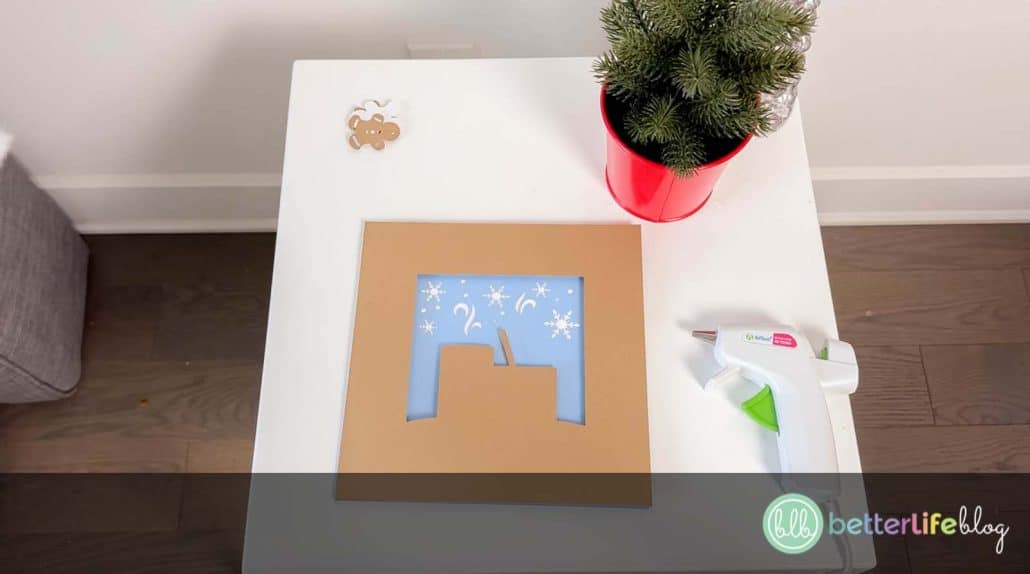 This DIY Hot Cocoa Shadow Box is a festive craft that features two mugs of hot cocoa, a candy cane, and gingerbread cookies—perfect for gifts, home decor, or craft fairs!
